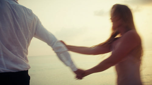 Romantic couple enjoying a beautiful tropical beach sunset vacation together