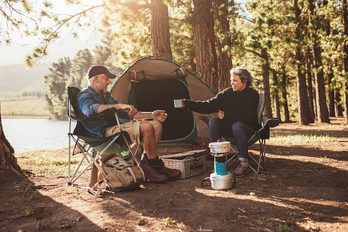 Senior couple camping by a lake
