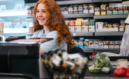 Cashier attending customer at supermarket