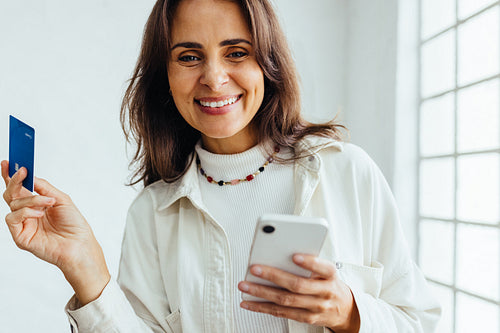 Business banking: Successful business woman making electronic payments with a credit card