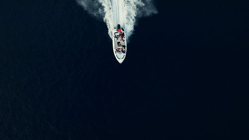 High angle view of a motorboat speeding across deep blue ocean water