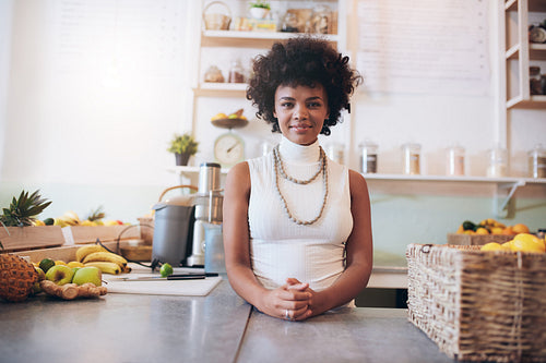 Attractive young woman working at juice bar