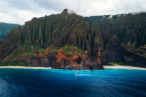 View of Kalalau Beach in Hawaii, with rugged cliffs and blue waters