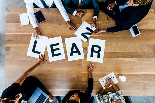Business team meeting with word Learn on table
