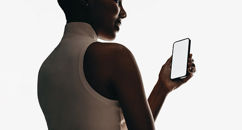 Woman holding smartphone with blank screen for app and UI mockups
