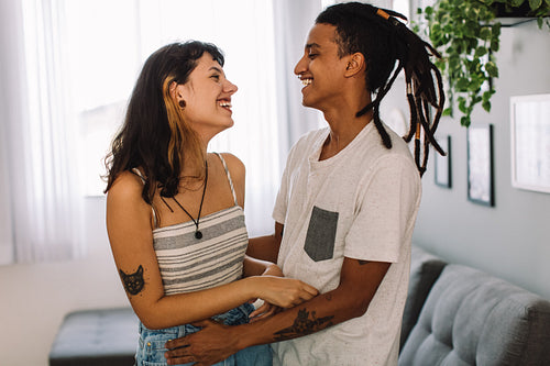 Young couple laughing together indoors
