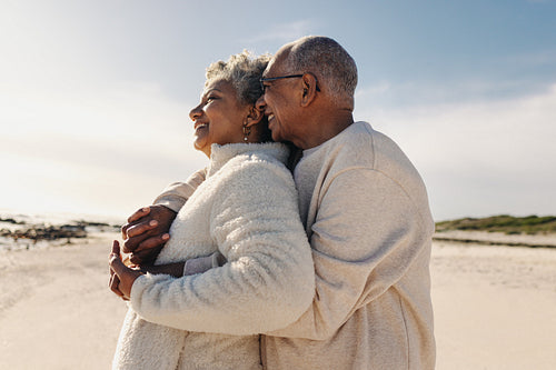 Senior couple enjoying a view of the ocean at the beach