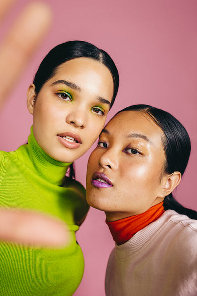 Makeup selfies in the studio; two female friends pose for the camera wearing flawless makeup