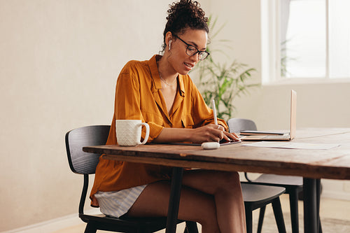 Woman using her digital tablet at home