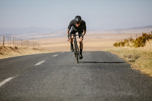 Professional cyclist training hard outdoors