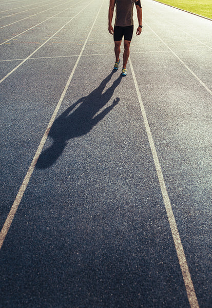 Sprinter walking on running track