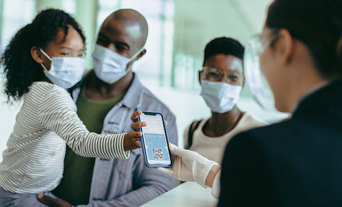 Girl with father showing medical pass to airline attendant