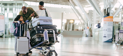 Family waiting for departure at airport terminal