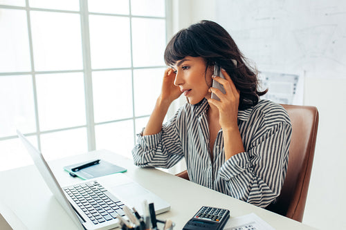 Female entrepreneur working in office on laptop