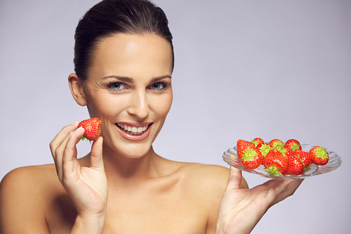 Gorgeous young woman with fresh strawberries