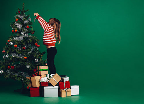 Kid decorating a christmas tree
