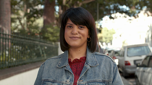 Attractive woman standing on sidewalk