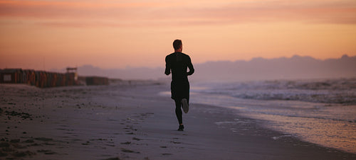 Man running by the sea in morning