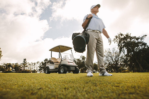 Senior golfer with bag on the golf course