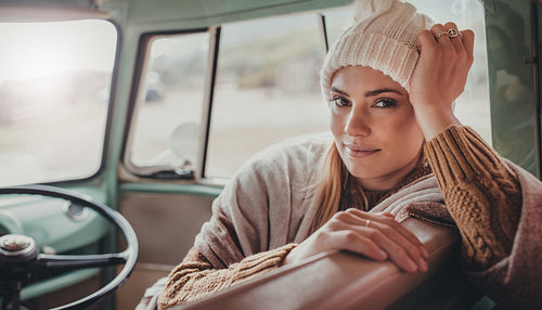 Beautiful woman on roadtrip travelling by van