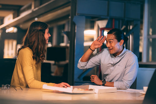 Smiling business people talking sitting in office