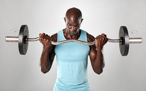 Portrait of a muscular man lifting barbell