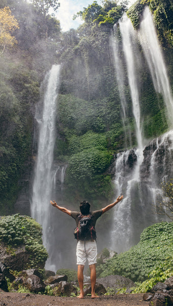 Male tourist enjoying near waterfall