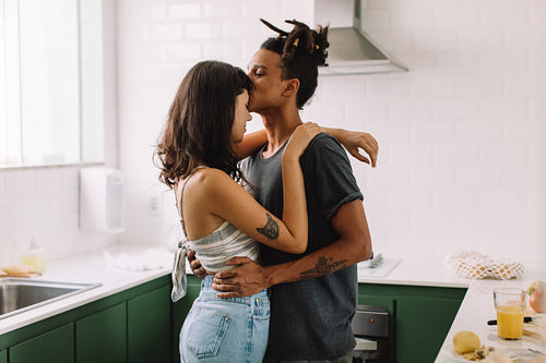 Passionate young couple bonding in the kitchen