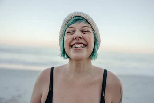 Cheerful winter bather smiling with her eyes closed