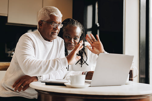 Senior couple having a video call at home