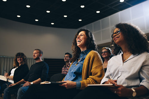 Businesswoman smiling during a seminar in convention center