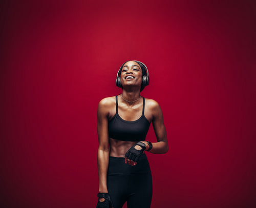 Fitness woman relaxing and listening music after her workout