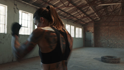 Sportswoman training boxing moves in gym