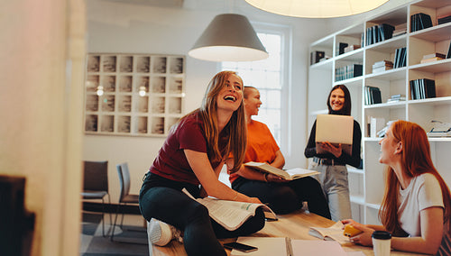 University friends studying together in library