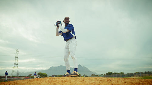 Pitcher delivers a fast ball during baseball game
