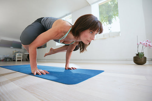 Fitness woman doing yoga handstand - Bakasana