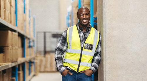 Cheerful warehouse voice picker smiling at the camera
