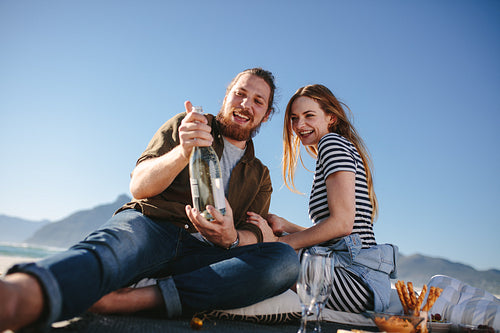Beautiful couple having a picnic on the beach