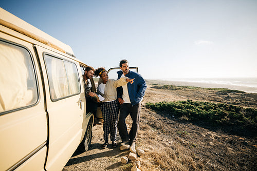 Road trip stop: Friends step out of the van into the sunshine