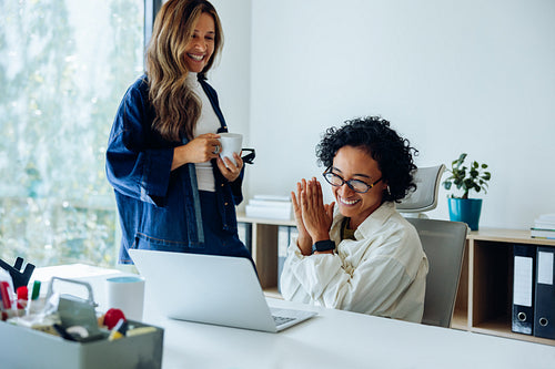 Two colleagues celebrate at the office
