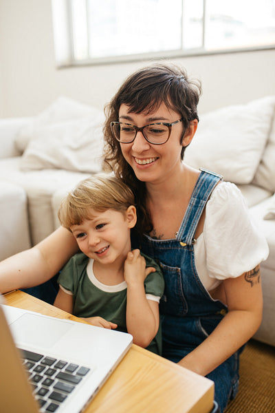 Mother and son watching cartoons at home
