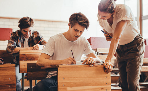 Teacher assisting the problem of a student in her classroom