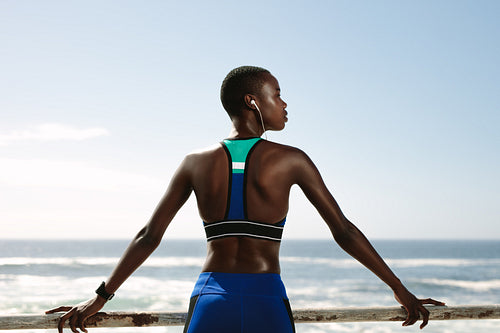 Woman in sportswear relaxing outdoors after workout