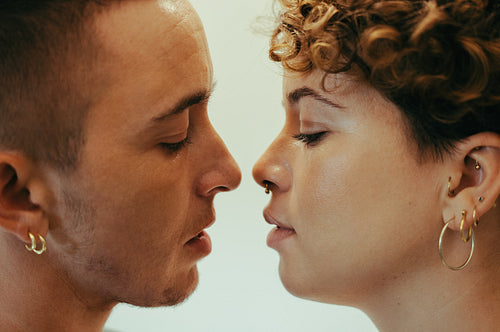 Young couple going in for a kiss indoors