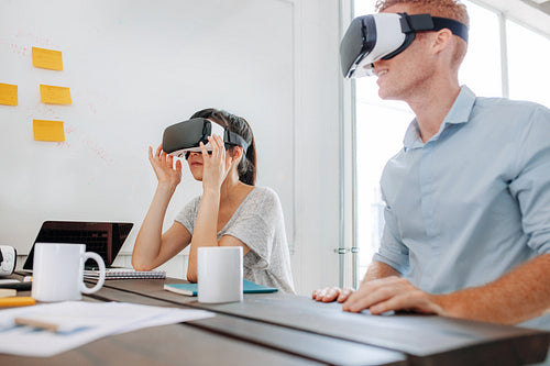 Business team using virtual reality headset in meeting