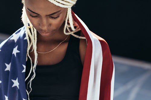 Female athlete with american flag on her back