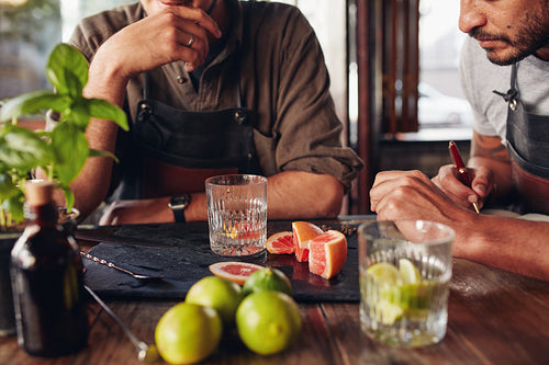 Bartenders experimenting with creating new cocktails.