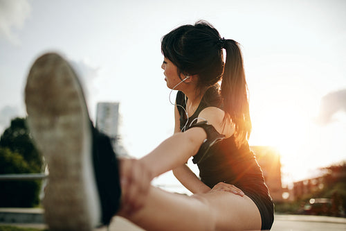 Female runner exercising in morning.
