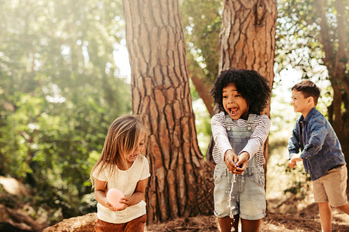Group of kids having fun in forest
