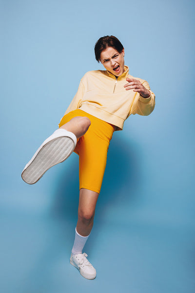 Active young woman dancing and having fun against a studio background